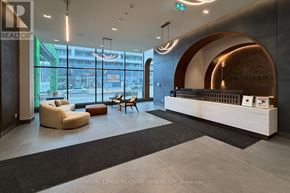Vaughan (Vellore Village) condo for rent - A reception area with a white reception desk and a large window.