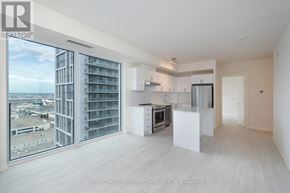 Vaughan (Vellore Village) condo for rent - A spacious, empty apartment with a view of the cityscape outside the large window.