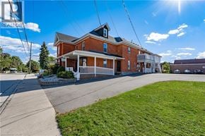 Waterdown apartment for rent - A house with a blue sign that says REALTOR in the background.