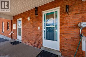 Waterdown apartment for rent - A red brick house with a white door and a sign that says "SOLD".