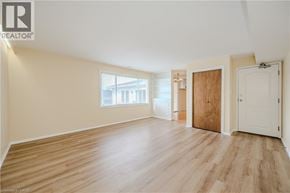 Waterdown apartment for rent - A room with wooden flooring and white walls.