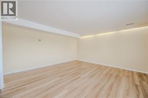 Waterdown apartment for rent - A room with wooden flooring and white walls.
