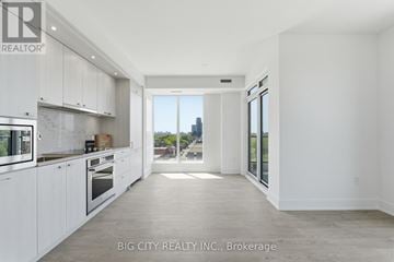 Toronto (Dovercourt-Wallace Emerson-Junction) condo for rent - A spacious kitchen with white cabinets and a view of the city.
