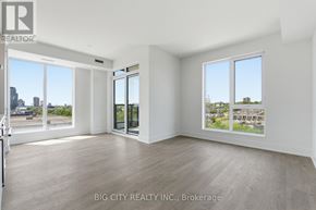 Toronto (Dovercourt-Wallace Emerson-Junction) condo for rent - A spacious room with a view of the cityscape through large windows.