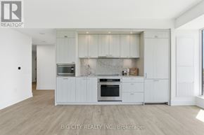 Toronto (Dovercourt-Wallace Emerson-Junction) condo for rent - A white kitchen with a wooden floor and a white ceiling.