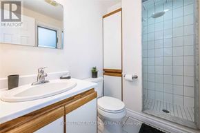 Mississauga (Creditview) apartment for rent - A white sink with a wooden counter top and a white toilet in a bathroom.
