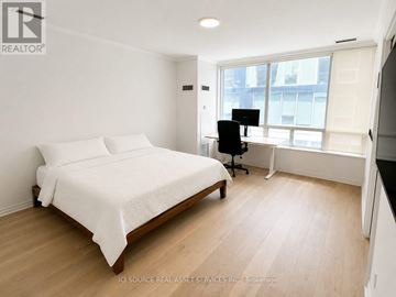 Toronto (Waterfront Communities) condo for rent - A bedroom with a bed, desk, and chair.