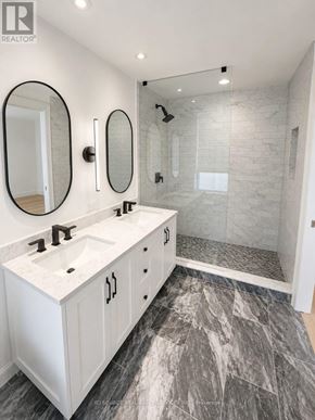 Toronto (Waterfront Communities) condo for rent - A bathroom with a marble floor and white walls.