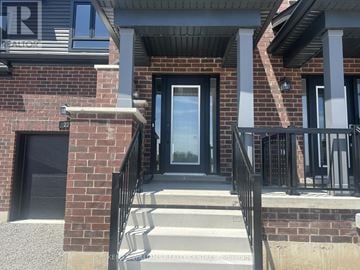 Barrie townhouse for rent - A house entrance with a black door and a glass window.
