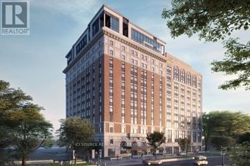 Hamilton (Beasley) condo for rent - A large, modern building with a glass facade is depicted in the image.