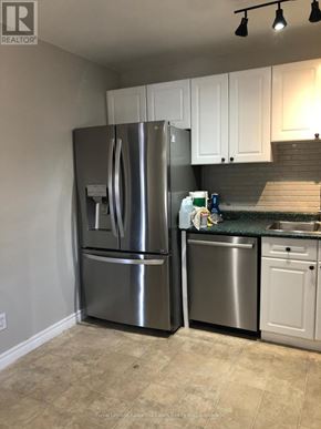 Kawartha Lakes (Lindsay) apartment for rent - A kitchen with a stainless steel refrigerator and a white dishwasher.