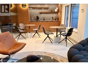 West Vancouver apartment for rent - A modern waiting area with a wooden bar and leather chairs.