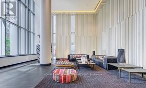 Toronto (Church-Yonge Corridor) condo for rent - A living room with a striped wall and a sofa.