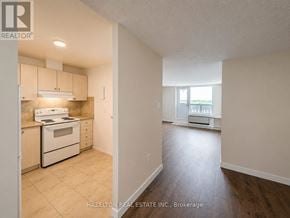Mississauga (Meadowvale) condo for rent - A kitchen with white appliances and wooden cabinets.