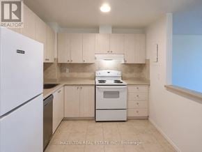 Mississauga (Meadowvale) condo for rent - A kitchen with a white fridge and stove.