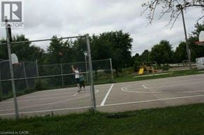 Kitchener townhouse for rent - A person is playing basketball on an outdoor court.