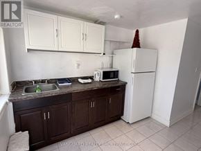 Bradford West Gwillimbury apartment for rent - A kitchen with white cabinets and a brown counter top.