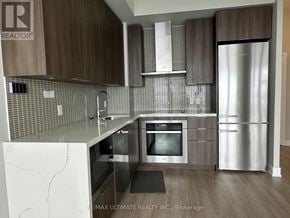 Toronto (Mimico) condo for rent - A modern kitchen with a refrigerator, oven, and sink.