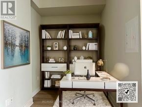 Toronto (Mimico) condo for rent - A room with a desk, a bookshelf, and a painting on the wall.