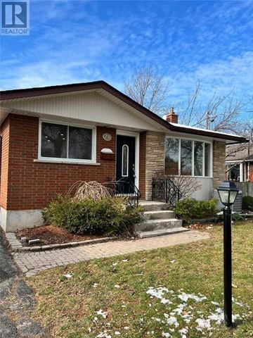 St. Catharines (Vine/Linwell) apartment for rent - A house with a black door and a small front yard.