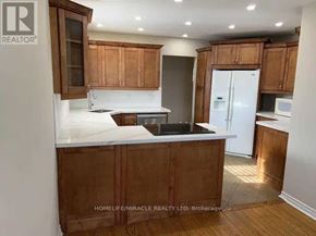 St. Catharines (Vine/Linwell) apartment for rent - A kitchen with wooden cabinets and a white countertop.