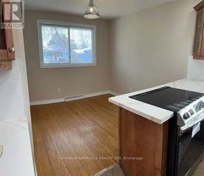 St. Catharines (Vine/Linwell) apartment for rent - A kitchen with a white stove top oven and wooden floors.