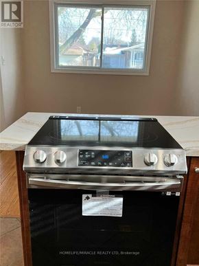 St. Catharines (Vine/Linwell) apartment for rent - A stove top oven with a window on top is in a kitchen.