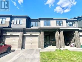 Ottawa townhouse for rent - A red car is parked in front of a house with a REALTOR® sign.