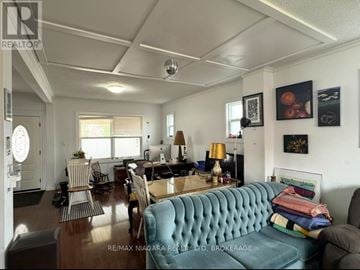 Niagara Falls (Clifton Hill) apartment for rent - A living room with a blue couch and a dining table.