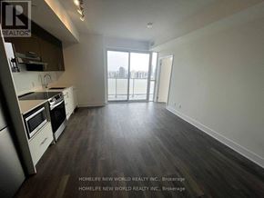 Toronto (Don Valley Village) condo for rent - A kitchen with dark wood floors and white appliances.