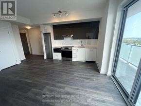 Toronto (Don Valley Village) condo for rent - A spacious kitchen with white cabinets and a dark countertop.