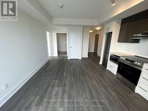 Toronto (Don Valley Village) condo for rent - A spacious room with a kitchen area and a dining table.