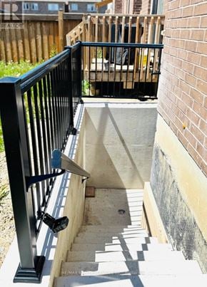 Brampton (Sandringham-Wellington North) apartment for rent - A staircase with a black railing leading to a concrete landing.