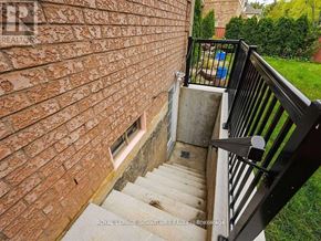 Mississauga (Central Erin Mills) apartment for rent - A staircase with a black railing leads up to a brick wall.