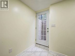 Mississauga (Central Erin Mills) apartment for rent - A white door with a window in the middle is in a room with white walls.