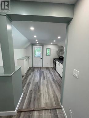 Hamilton (Stipley) duplex for rent - A hallway with wood flooring and white walls.