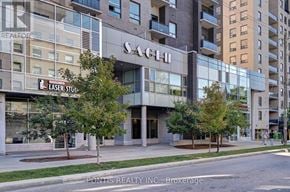 Waterloo condo for rent - A building with the word "SACEN" on it is in front of other buildings.