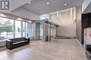 Waterloo condo for rent - A spacious lobby with a black sofa and a large window.