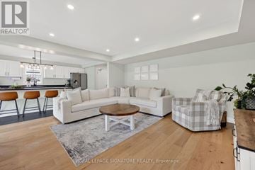 Gravenhurst (Muskoka (S)) apartment for rent - A modern living room with a white sofa set and wooden flooring.