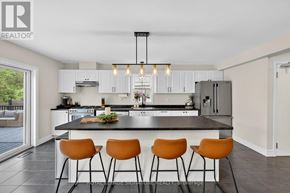 Gravenhurst (Muskoka (S)) apartment for rent - A modern kitchen with a large island and bar stools.