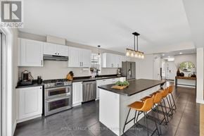 Gravenhurst (Muskoka (S)) apartment for rent - A modern kitchen with white cabinets and a central island.