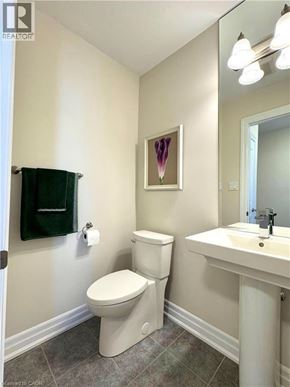 Niagara-On-The-Lake townhouse for rent - A white toilet sits next to a sink in a bathroom.