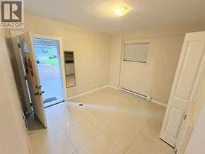 Vancouver apartment for rent - A white tiled room with a sliding glass door leading outside.