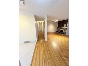 Vancouver apartment for rent - A room with wooden floors and white walls.