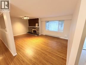 Vancouver apartment for rent - A room with wooden flooring and a fireplace.