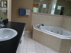 Richmond apartment for rent - A bathroom with a black counter top and a white sink.