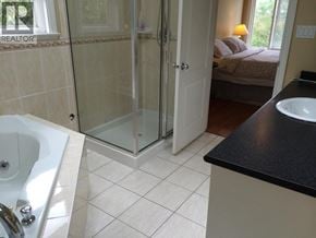 Richmond apartment for rent - A bathroom with a white sink and a glass shower door.