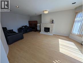 Vancouver apartment for rent - A living room with a fireplace and a couch.