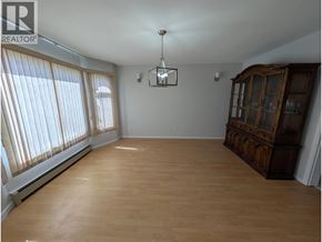Vancouver apartment for rent - A large empty room with wooden floors and a cabinet.