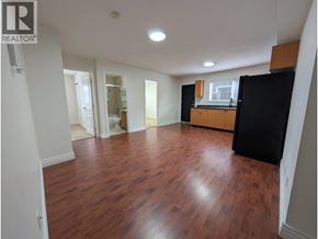 Richmond apartment for rent - A large empty room with wooden floors and white walls.